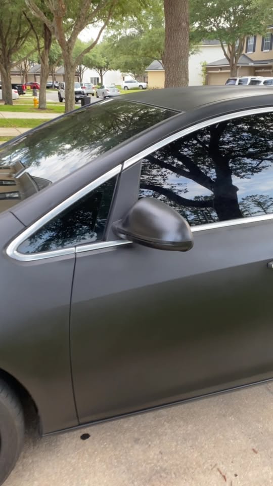 Matte black car with dark window tint completed by Superb Job